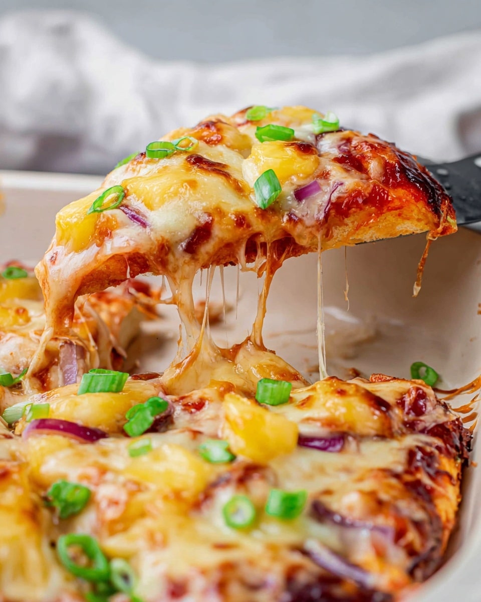 A close-up of a cheesy pizza slice being lifted from a white pan, showing at least three layers: a golden, slightly browned melted cheese layer on top with chopped green onions scattered, below it a layer of red tomato sauce, and at the bottom pieces of golden-yellow pineapple and small bits of red onion visible through the melty cheese. The cheese stretches with stringy texture as the slice is lifted against a white marbled surface with a soft blurred background. The green onions add a fresh pop of green on the warm colors of the cheese and pineapple. photo taken with an iphone --ar 4:5 --v 7