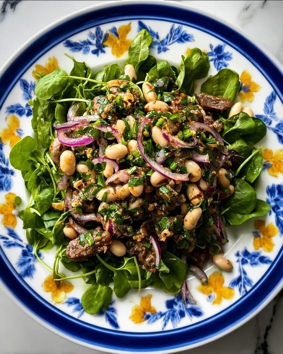A white plate with blue and yellow flower designs holds a fresh salad. The bottom layer consists of green watercress leaves spread evenly on the plate's surface. On top of the greens, there is a mix of ingredients including white beans, thinly sliced red onions, chopped green herbs, and chunks of cooked brown meat. The salad looks moist and well mixed, with a variety of colors and textures from creamy beans, crunchy onions, fresh greens, and tender meat. The background is a white marbled texture. photo taken with an iphone --ar 4:5 --v 7