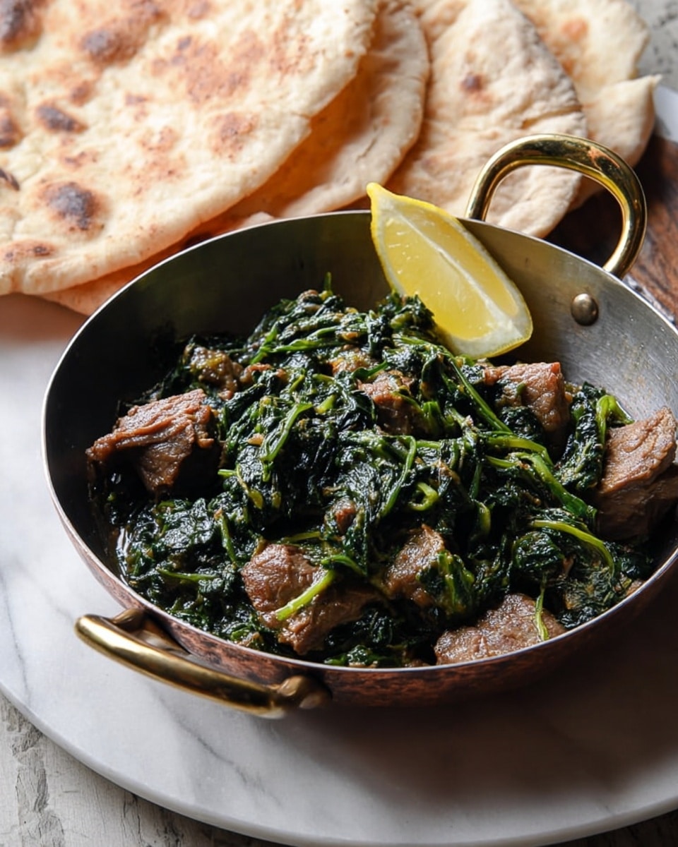 A round pan with two bronze handles sits on a round white plate, placed on a white marbled surface. Inside the pan is a dish with chunks of brown meat and dark green cooked spinach mixed together. On the right side, a bright yellow lemon wedge rests on top. Behind the pan is a folded flatbread with a light tan crust and soft texture, adding a warm color to the scene. The light shines softly on the food, showing the moist texture of the spinach and tenderness of the meat. photo taken with an iphone --ar 4:5 --v 7