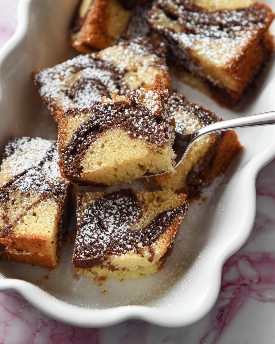 The image shows several slices of marble cake arranged in a white, wavy-edged dish. Each slice has two main layers: a light golden cake layer and a dark brown chocolate swirl running through the middle and top, creating a marbled effect. The surface of the cake is slightly crumbly with some darker baked spots, and the slices are dusted with a fine layer of white powdered sugar. A metal spoon is placed among the slices, lifting one piece slightly. The dish rests on a white marbled surface. photo taken with an iphone --ar 4:5 --v 7