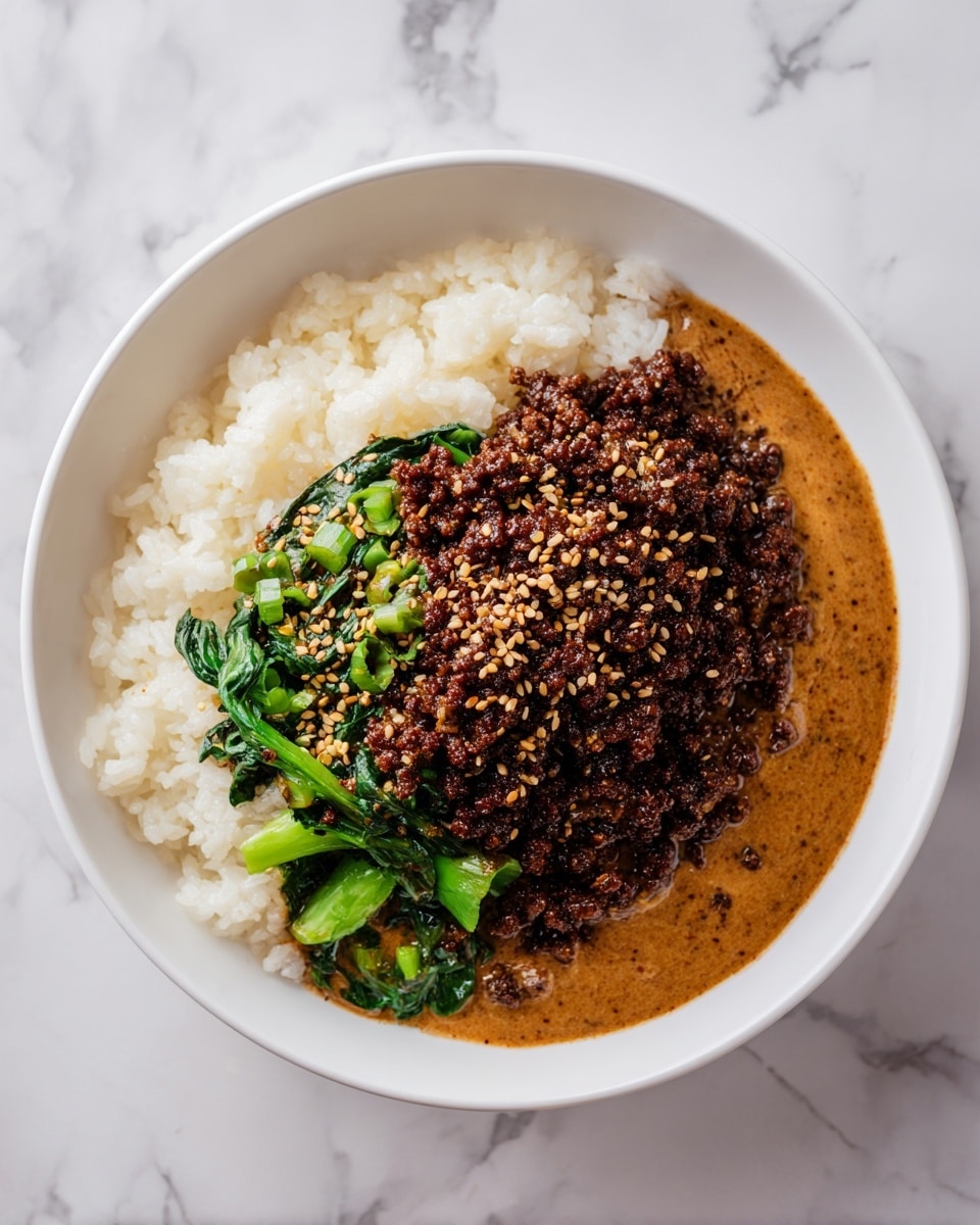 A white bowl with three main layers: the bottom layer is a smooth, light brown sauce with a creamy texture that spreads to the edges; above that is a middle layer of soft, fluffy white rice with some grains slightly sticking out; the top layer consists of dark brown, finely cooked minced meat with a slightly crispy look, scattered with small, golden sesame seeds, along with some bright green cooked vegetables partly mixed in; the bowl sits on a white marbled texture surface. photo taken with an iphone --ar 4:5 --v 7